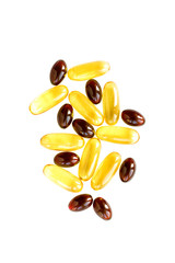 Yellow and red gelatin pills on white background