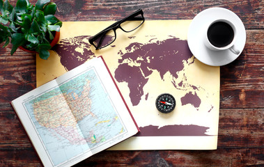 world map with coffee on wooden table top view