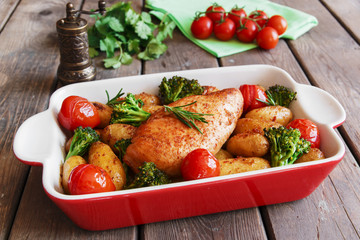 Chicken breast baked with tomato new potatoes and broccoli