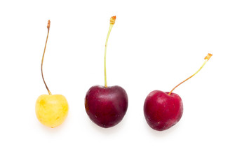 red and yellow cherries on white background