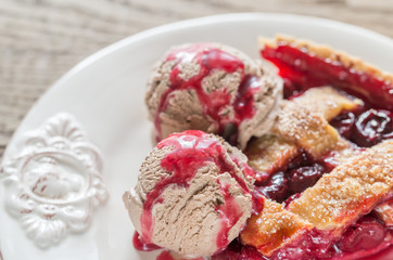Fototapeta na wymiar Slice of cherry pie with balls of chocolate ice cream