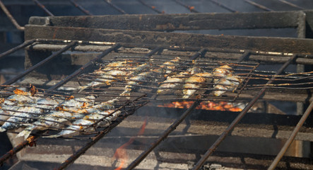 Fried fish on a hot coal.