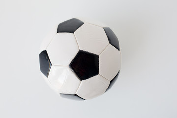 close up of football or soccer ball over white