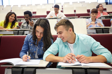 group of students with notebooks at lecture hall