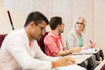 group of students with notebooks in lecture hall