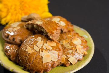 Typical Dutch filled spicy  cookies with almonds on autumn colors on black