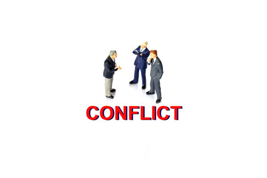 Miniature businessman with conflict concept