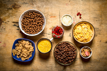 Cereal in cups. On wooden background.