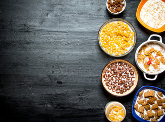 Different cereals with milk.