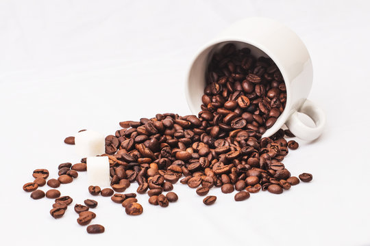 Coffee beans with white cup of coffee