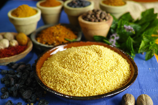 Organic yellow couscous and different spices in traditional oriental style