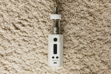 E-cigarette or vaping device on a neutral background. Next to them are the books
