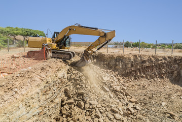 Obraz premium Excavator, digger clears ground for house building