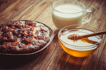 Fruit cake, honey and milk.