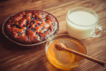 Fruit cake, honey and milk.