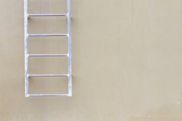 horizontal photo of blank wall background with old hanging ladder