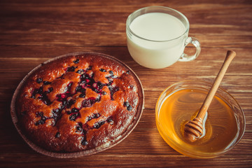 Fruit cake, honey and milk.