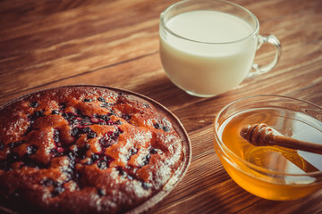 Fruit cake, honey and milk.