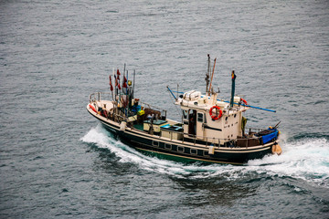 Fototapeta premium Fishing boat sailing in the atlantic Ocean. San Sebastian, Basque Country. Spain