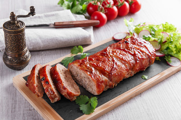 baked bacon wrapped meatloaf with salad