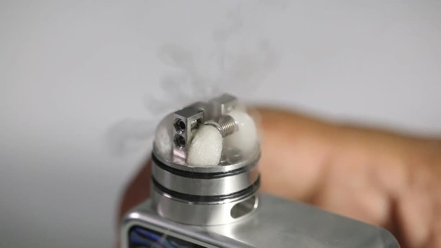 showing burn of e juice or e liquid in the coil, wire and cotton inside the atomizer of electronic cigarette for vaping, close up scene, high definition, Full HD, 1920x1080