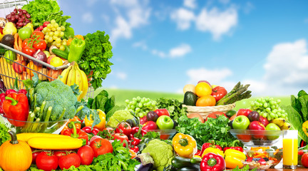 Vegetables and fruits over blue sky background.