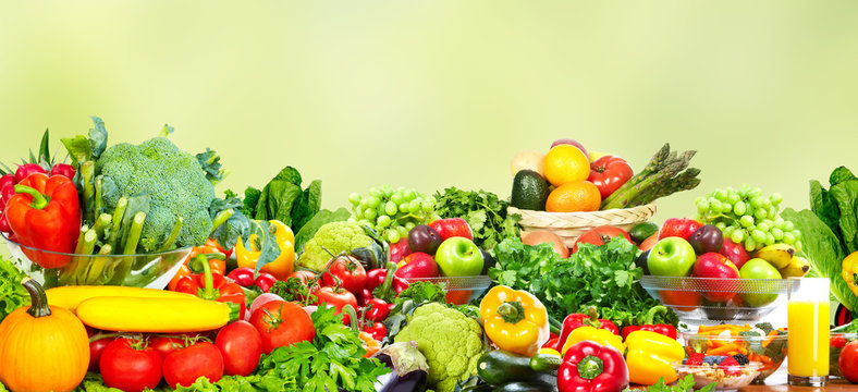 Vegetables and fruits over green background.