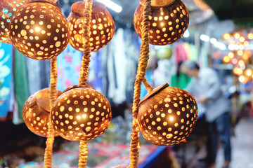 Asian decorative lights handmade from coconut shell for sale in a local night market background