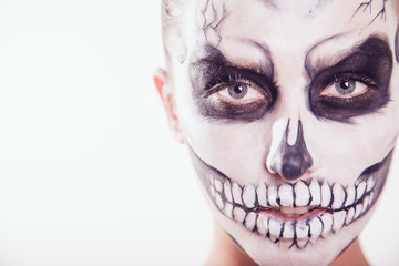 Girl with Halloween face art on white background