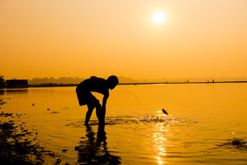 Silhouette Fisherman near U Bein bridge in Amarapura,Mandalay  ,