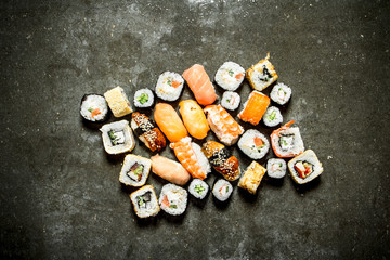 Different sushi and rolls with seafood.