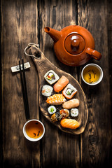 Sushi and rolls with herbal tea.