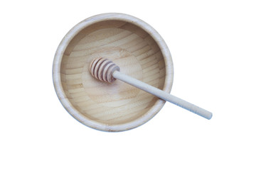 Honey stick in bamboo wooden bowl isolated