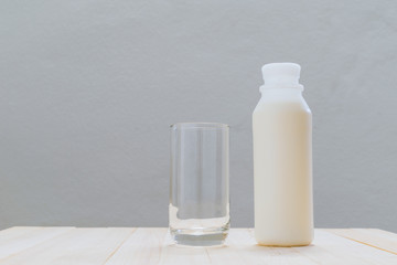 Glass of milk on a wooden floor