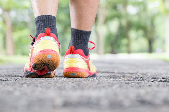 Leg of man walking on road at public park and closeup shoe. Spor © comzeal