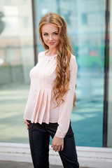 Obraz premium Beautiful brown-haired young woman wearing clothes and walking o