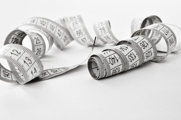 Flexible measuring tape on a white background