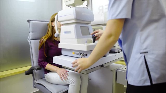 Customer sit behind optometry devices 4K