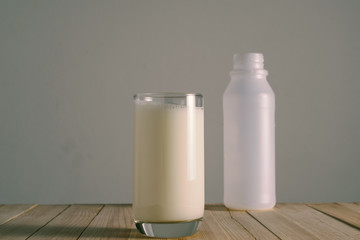 Glass of milk on a wooden floor