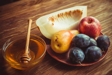 The new crop of fruit and honey on the table.