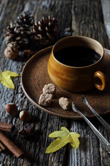 Cup of coffee, nuts and autumn leaves