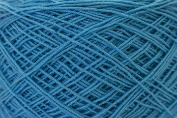 Close up of blue ball of wool yarn and knitting needles. Handcraft equipment used for needlework as a hobby