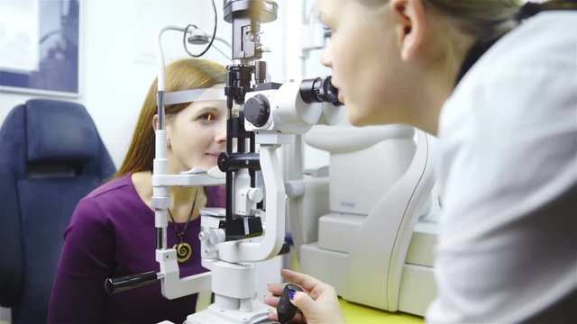 Doctor checking eyes with biomicroscope device 4K