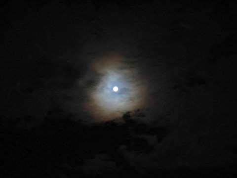 Dramatic photo of a nighttime sky with brightly lit full moon