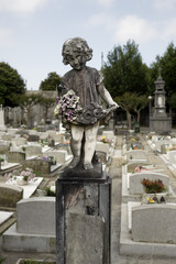 Weathered cemetery old child statue
