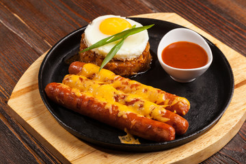 sausages in a pan with cheese