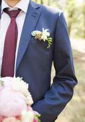 Boutonniere groom in a blue suit