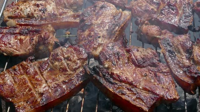 Close up of Pork Meat Steak on Barbecue Grill
