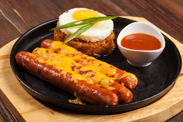 sausages in a pan with cheese