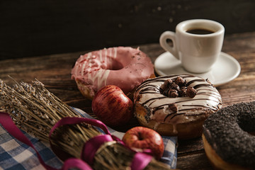 Obraz na płótnie Canvas Donuts and coffee on wooden table